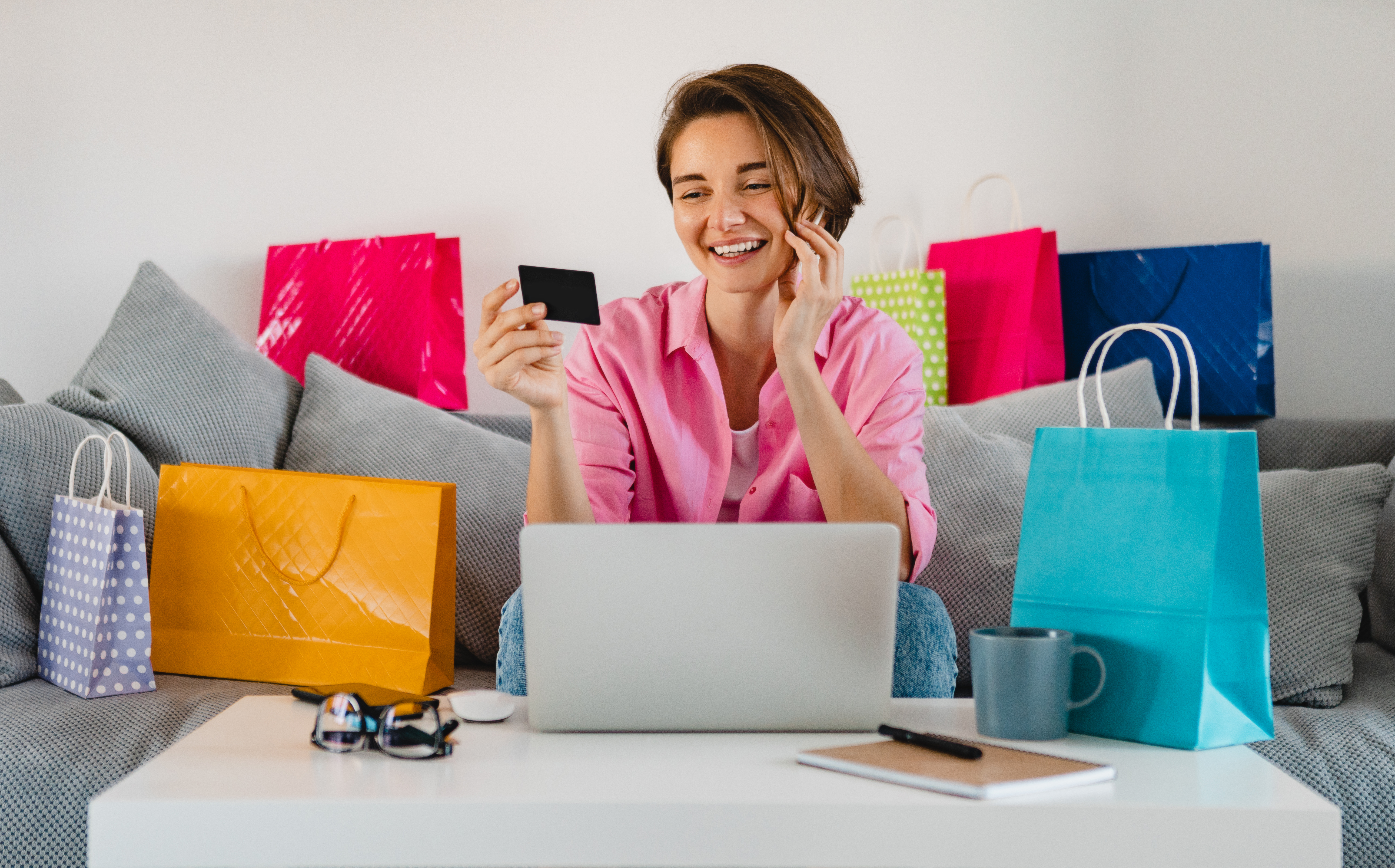 happy-smiling-woman-pink-shirt-sofa-home